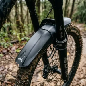 Close-up of a front mountain bike mtb mudguard installed on a suspension fork bridge.