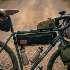 A saddle tool roll laid flat showing on-trail repair gravel bike accessories including a multi-tool and tubeless tire plugs.