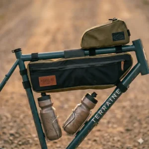 Heavy-duty cargo cages and bikepacking gravel bike accessories bolted to front fork mounts holding lightweight dry bags.